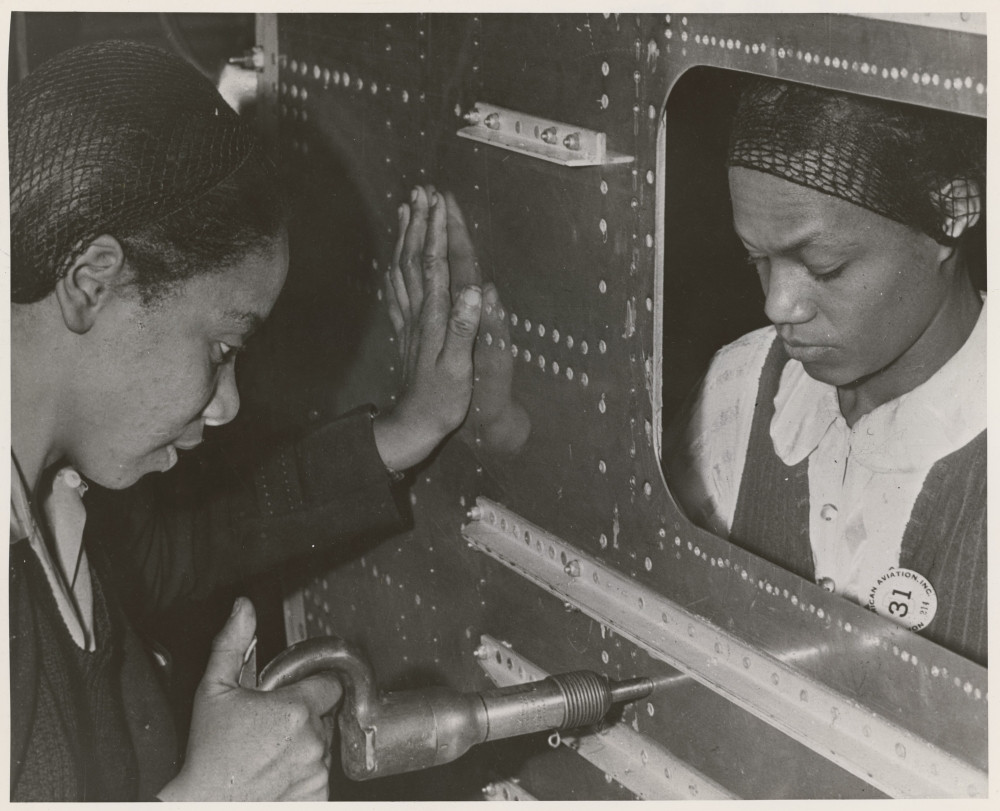 African American Women Riveters Work On The Center Section Of A Bomber