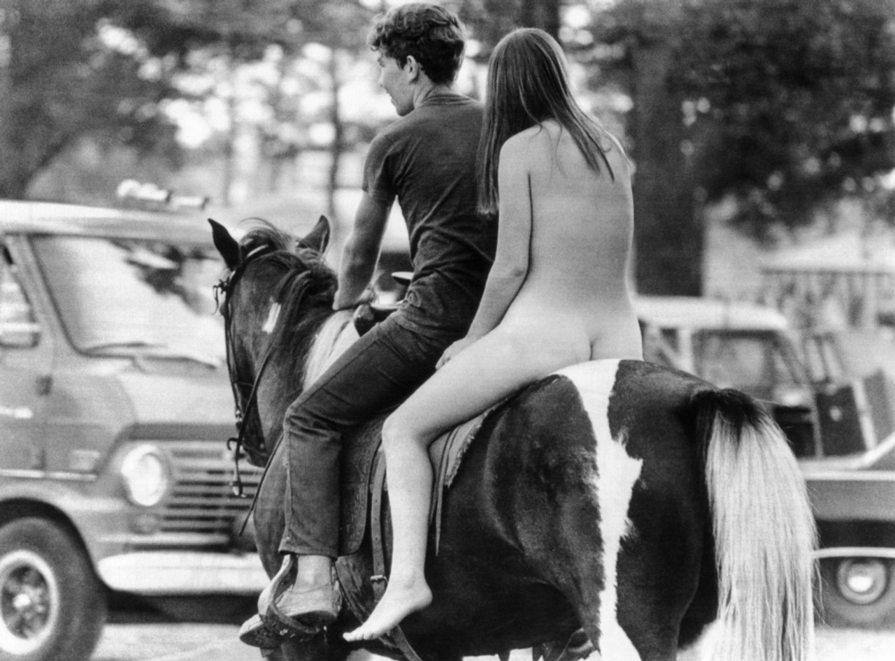 young naked girls and horses A Naked Young Women And Her Escort Ride A Horse Through Goose Lake Park During The