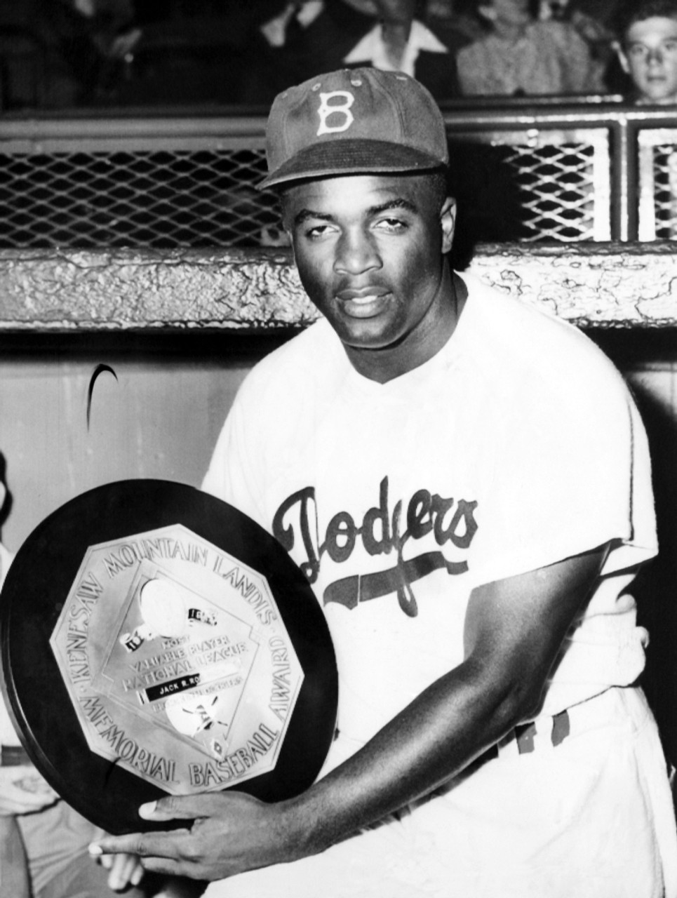 Baseball Player Jackie Robinson Of The Brooklyn Dodgers Holds His