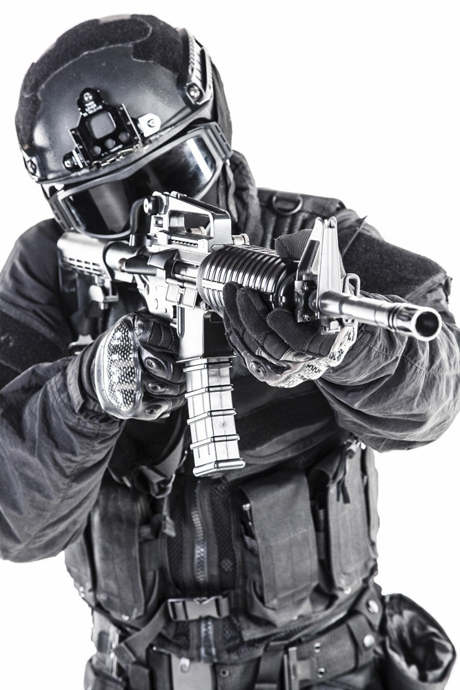 Spec ops police officer SWAT in black uniform and face mask