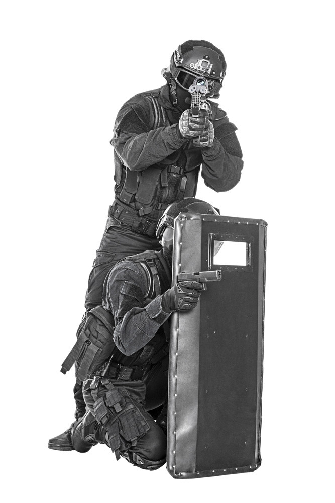 Team of SWAT police special forces with pistol and rifle, hiding