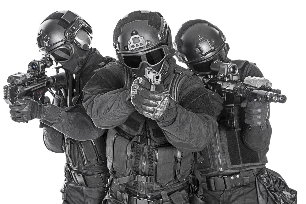 Studio shot of SWAT police special forces in black uniforms