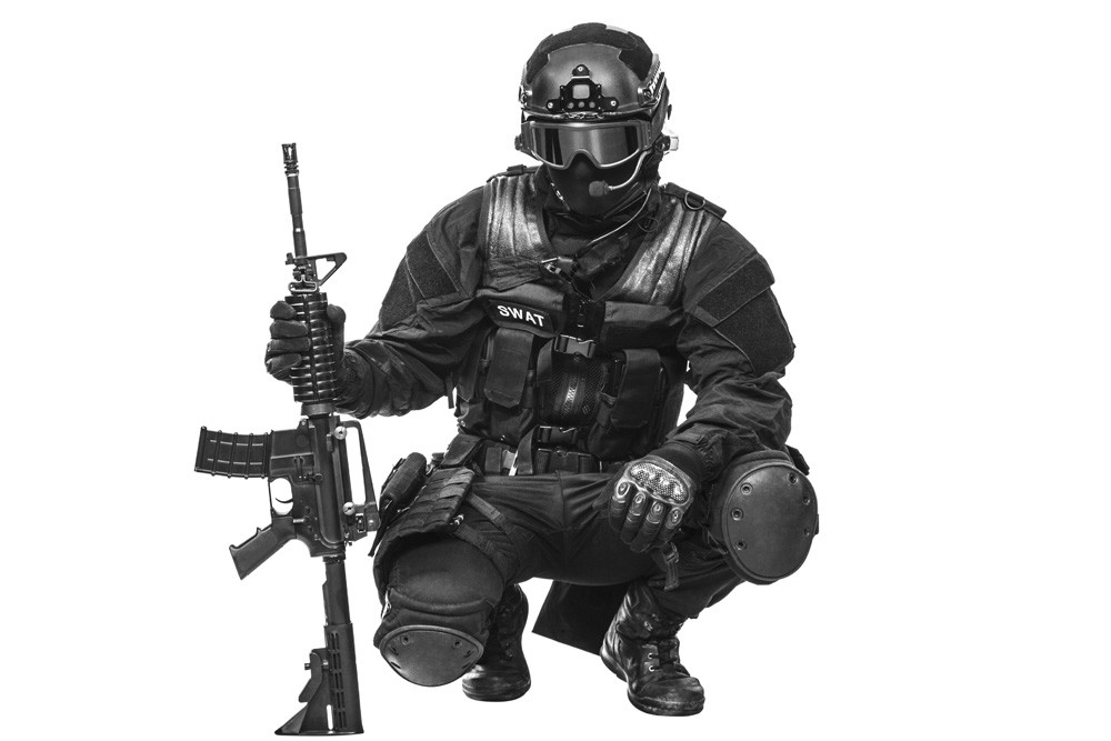 Spec ops police officer SWAT in black uniform and face mask
