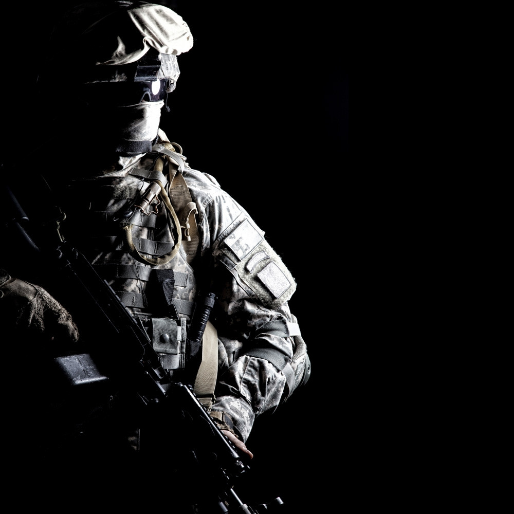 Army soldier with hidden face under the cover of darkness. Poster