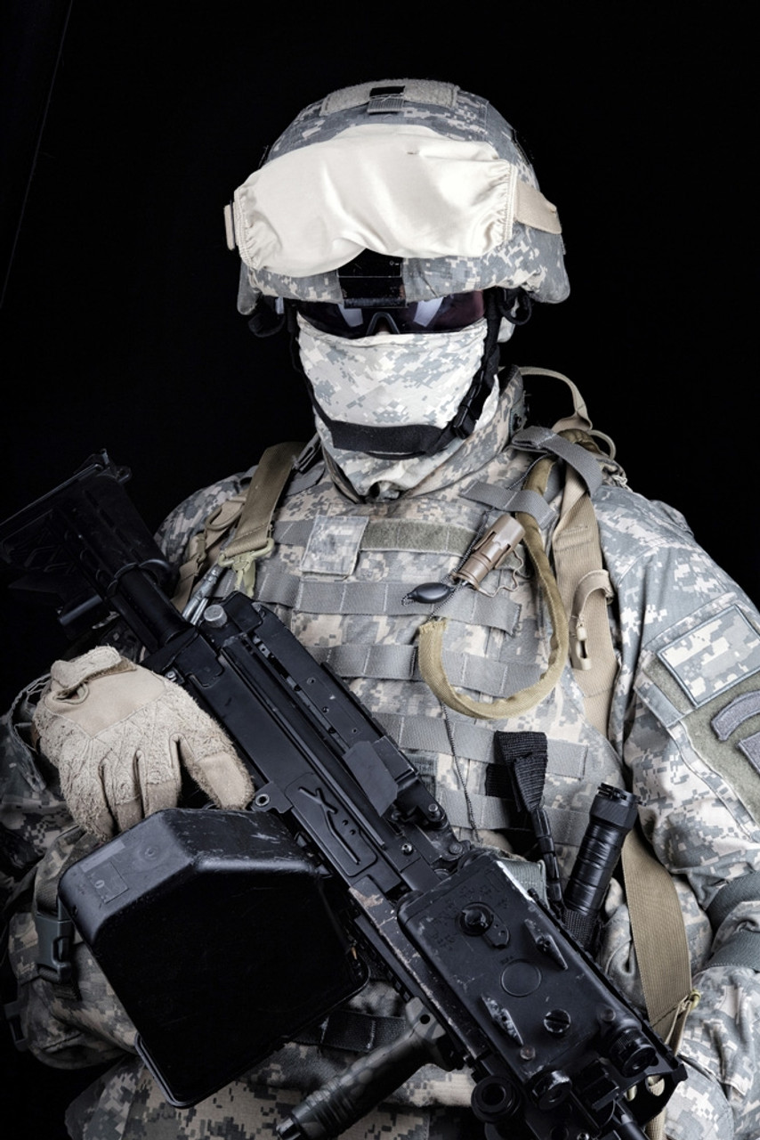 U.S. Marine in digital camouflage combat uniform, holding a light