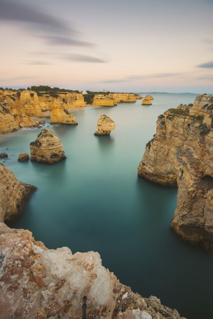 Iconic rock formations and turquoise water of the Atlantic Ocean at Praia  da Marinha along the