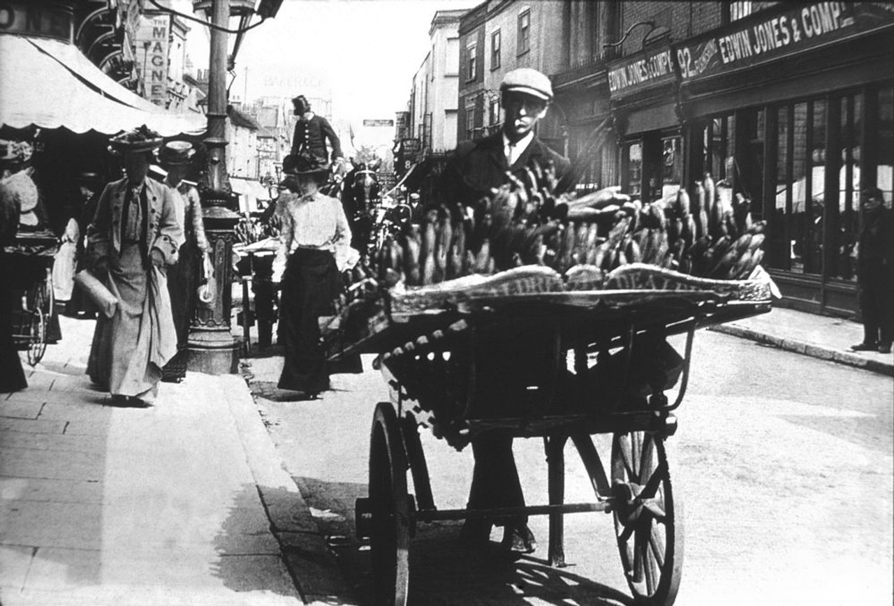 Magic lantern slide circa 1900 .Victorian/Edwardian.Social History. Slide  set: a barrow boy selling fruint in the main street of Southampton Poster 