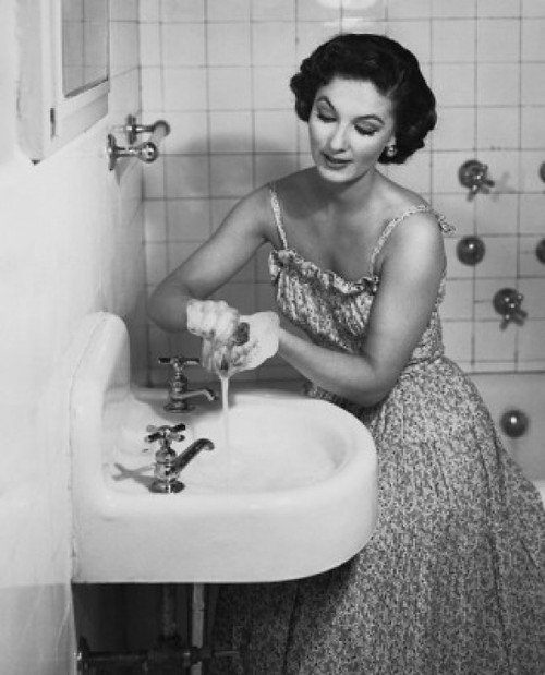 Young woman washing her hands in the bathroom sink Poster Print - Item # VARSAL25541901