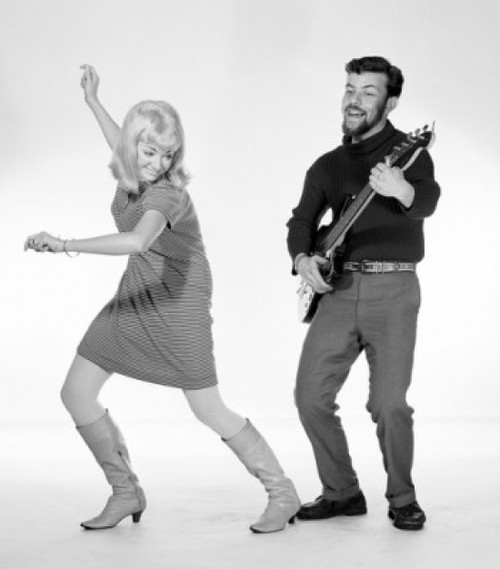 Woman dancing to man playing guitar Poster Print
