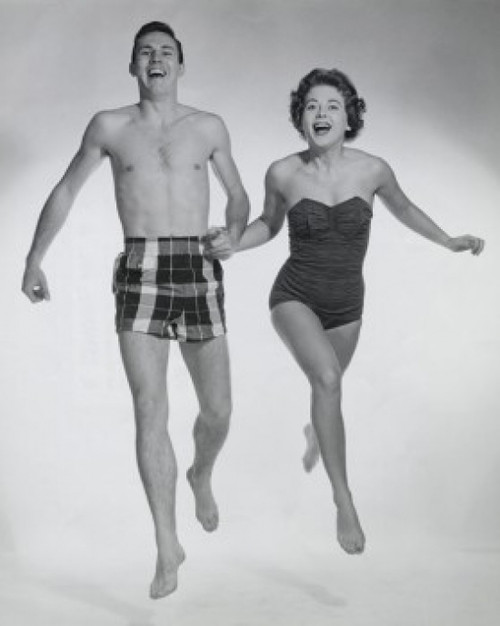 Young couple running together holding hands Poster Print - Item # VARSAL25526834