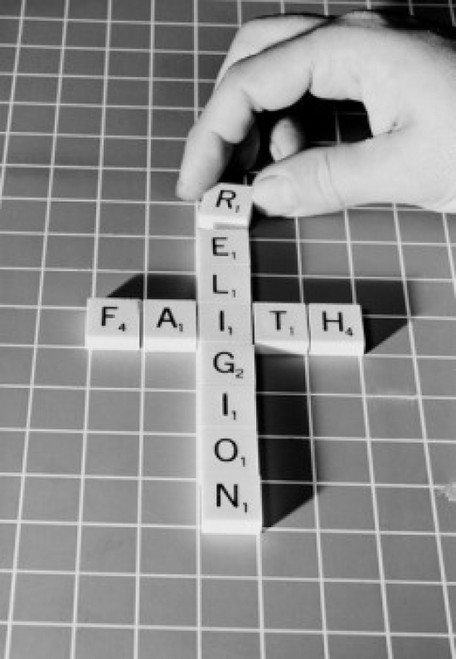 Mans hand making religious cross from scrabble pieces Poster Print - Item # VARSAL255421403