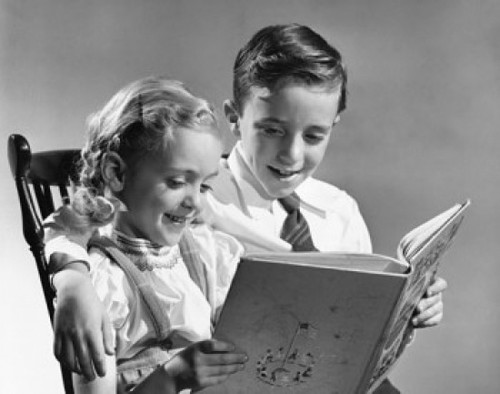 Boy and girl reading a book Poster Print - Item # VARSAL25591484