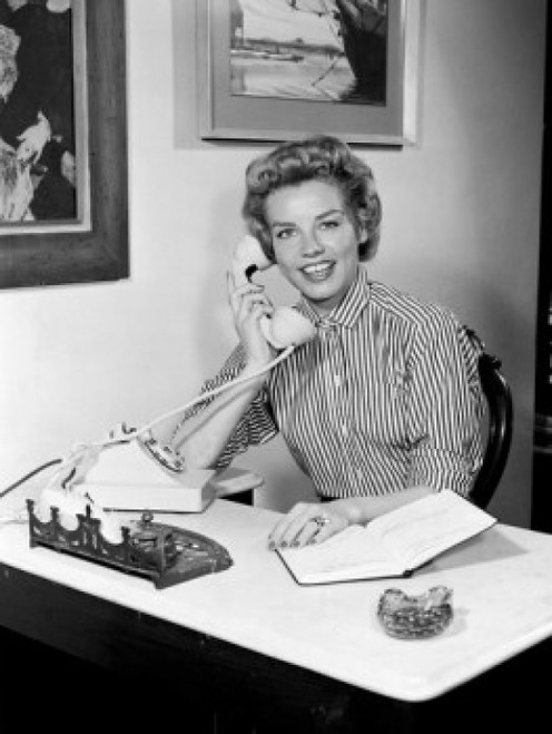 Portrait of young woman using telephone in office Poster Print - Item # VARSAL255416854