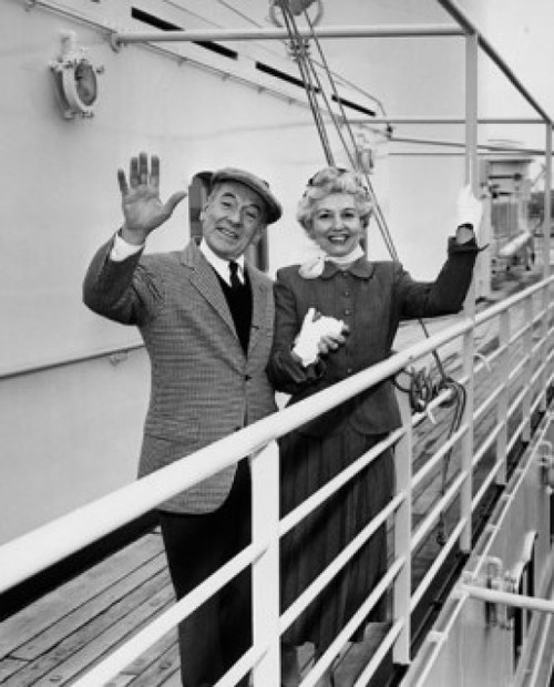 Portrait of a senior couple standing on a ship waving Poster Print - Item # VARSAL25523994
