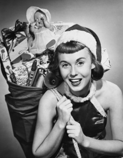 Portrait of a young woman carrying a sack of Christmas presents on her back Poster Print - Item # VARSAL25516085A