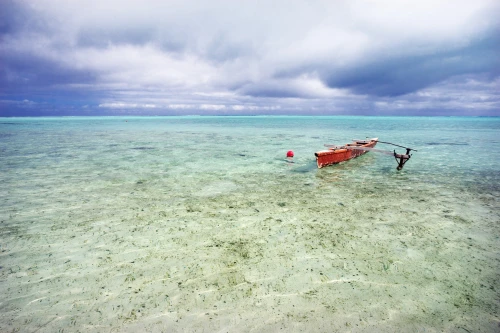 French Polynesia, Tahiti, Bora Bora, Red Outrigger Canoe In Calm Turquoise Water. PosterPrint - Item # VARDPI1975868