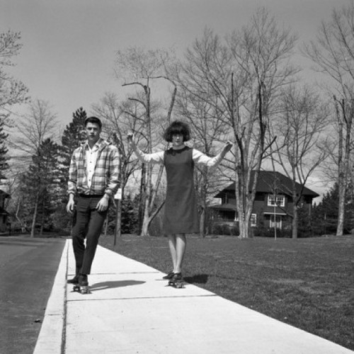 Young couple skateboarding on pavement Poster Print - Item # VARSAL255418387