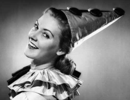 Portrait of a young woman wearing a clown's costume and smiling Poster Print