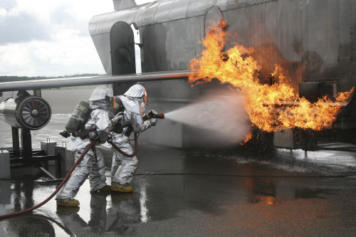 August 10, 2010 - Firefighters attack the exterior fire that has erupted outside of the mobile aircraft fire training device during a training exercise. Poster Print - Item # VARPSTSTK104287M