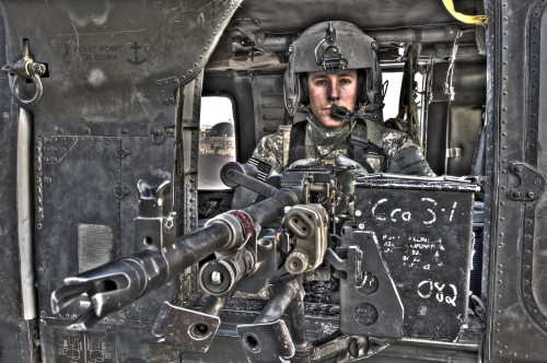 High dynamic range image of a UH-60 Black Hawk door gunner manning a M240B machine gun, Tikrit, Iraq Poster Print - Item # VARPSTTMO100690M