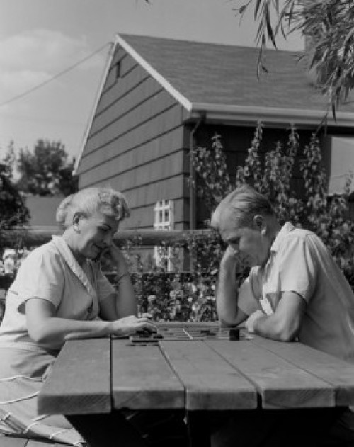 Couple playing draughts at outdoor table Poster Print - Item # VARSAL255422165