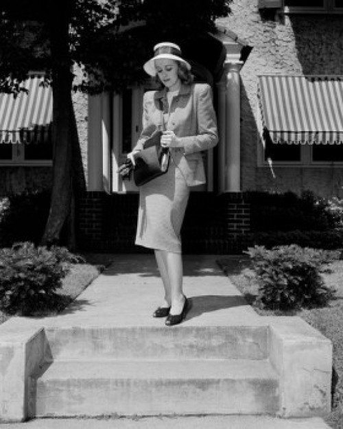 Young elegant woman standing in front of house Poster Print - Item # VARSAL255422351