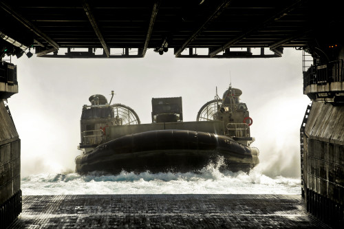 A landing craft air cushion prepares to enter the well deck of the assault ship USS Bonhomme Richard Print - Item # VARPSTSTK103820M