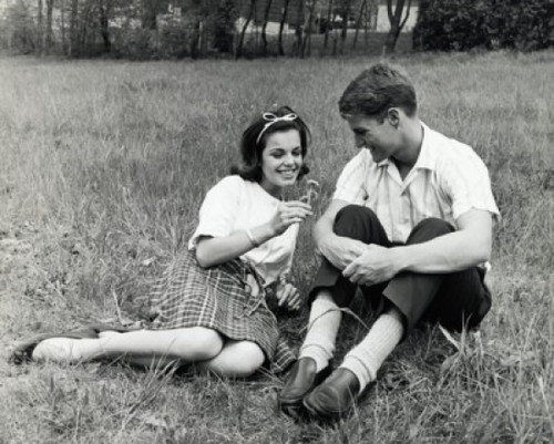 Young couple sitting in a park smiling Poster Print - Item # VARSAL2553872