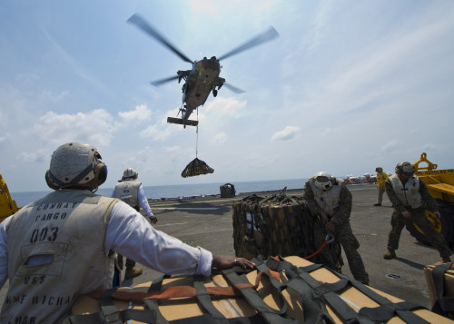 An MH-60s Sea Hawk helicopter lowers cargo to the flight deck of USS Bonhomme Richard Poster Print - Item # VARPSTSTK106828M