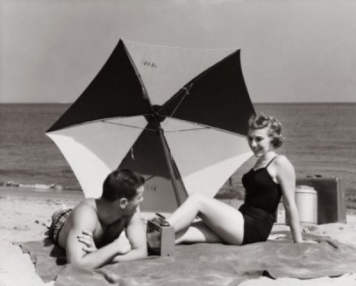 Young couple relaxing on the beach Poster Print - Item # VARSAL2558561