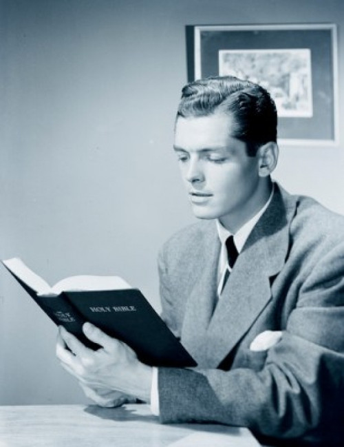 Businessman reading bible in office Poster Print - Item # VARSAL255417267