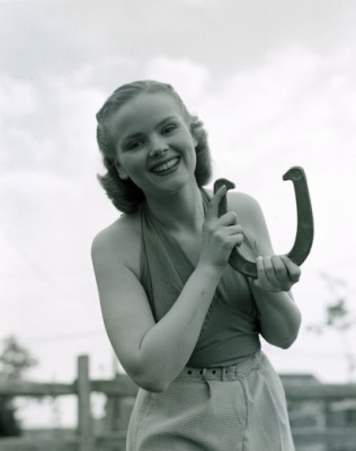 Portrait of young woman holding horse shoe outdoors Poster Print - Item # VARSAL255417323