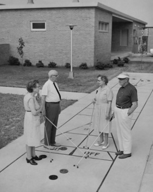 Two senior couples playing shuffleboard Poster Print