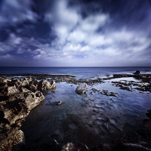 Rocky shore and tranquil sea against cloudy sky, Portoscuso, Sardinia, Italy. Poster Print - Item # VARPSTEVK200077S