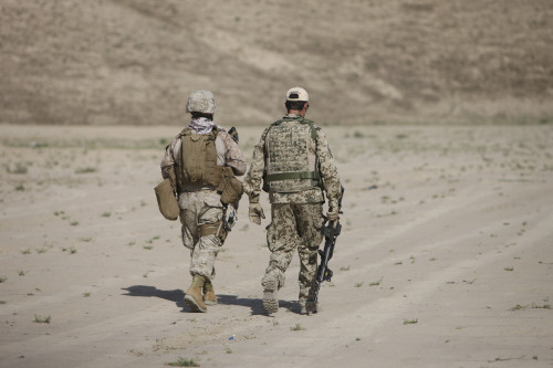 U.S. Marine and German Coalition soldier walk in a wadi near Kunduz, Afghanistan Poster Print - Item # VARPSTTMO100321M U.S. Marine and German Coalition soldier walk in a wadi near Kunduz, Afghanistan Poster Print - Item # VARPSTTMO100321M