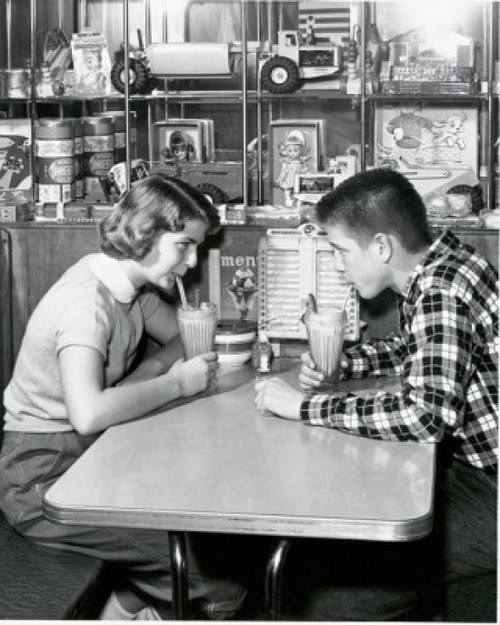 Side profile of a young couple drinking a milkshake in a restaurant  1954 Poster Print - Item # VARSAL2555476