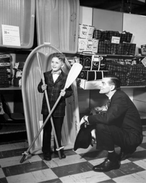 Boy holding two oars in a store and a salesman looking at him Poster Print - Item # VARSAL25543680