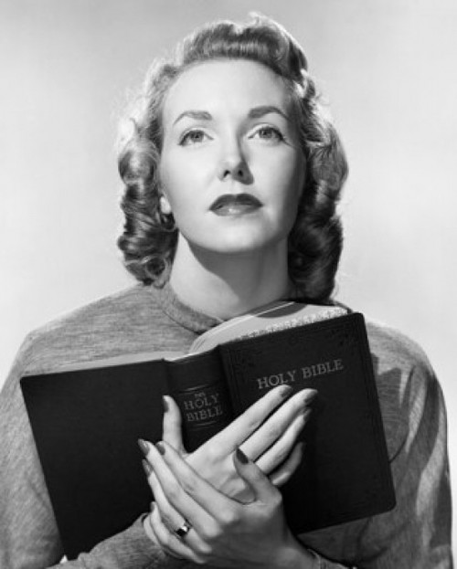 Close-up of a young woman holding the Bible Poster Print - Item # VARSAL2552852A