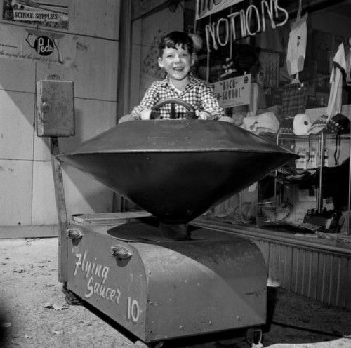 Boy in toy ride outside store Poster Print - Item # VARSAL255417560