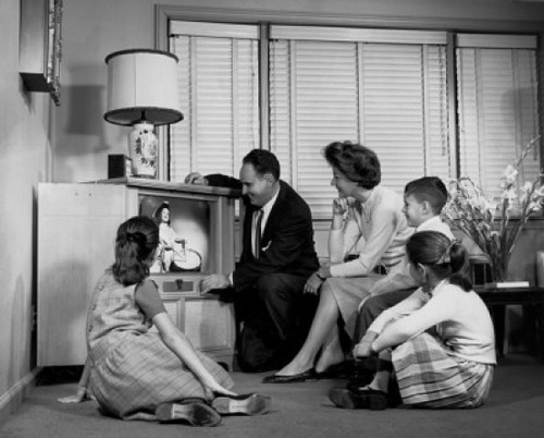 Parents with their three children watching television Poster Print - Item # VARSAL2551048