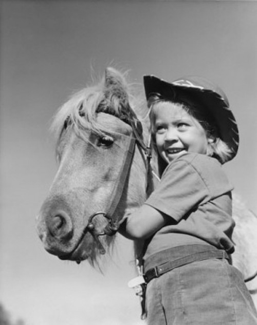 Low angle view of a girl standing with a horse and smiling Poster Print - Item # VARSAL25514206