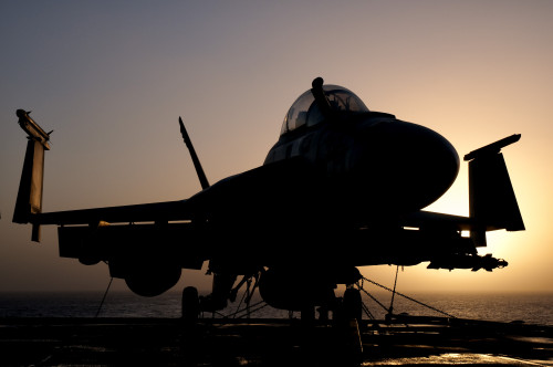 Silhouette of a US Navy F/A-18E Super Hornet parked on the flight deck of aircraft carrier USS Nimitz off the coast of Pakistan Poster Print - Item # VARPSTGCA100099M