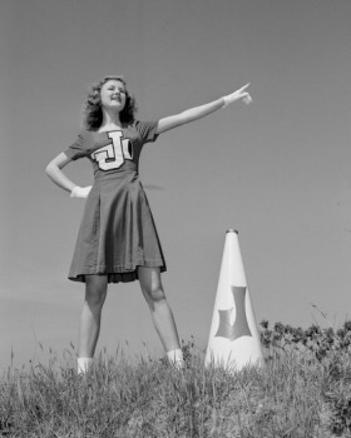Cheerleader with megaphone in meadow Poster Print - Item # VARSAL255422364
