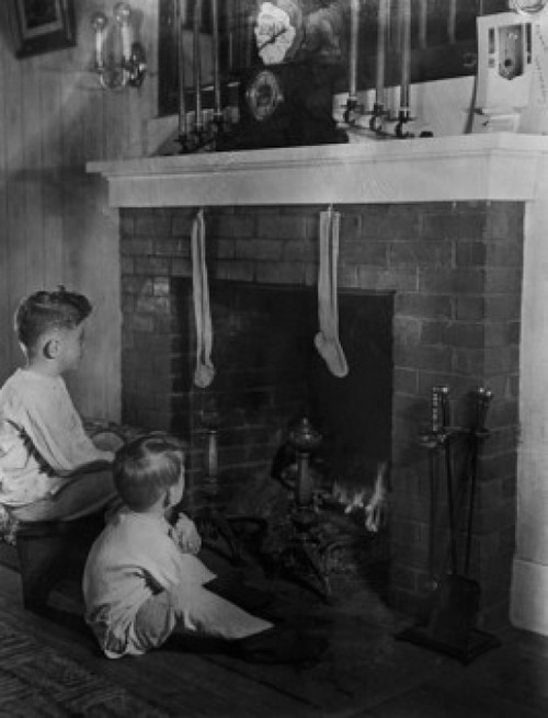 Two boys sitting in front of fireplace looking at christmas stockings Poster Print - Item # VARSAL255424015