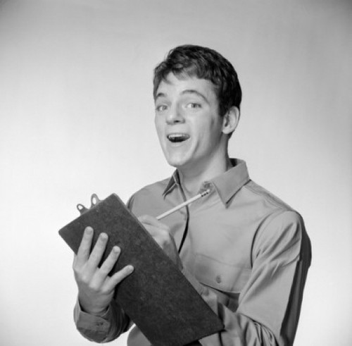 Young man holding writing pad making a face Poster Print - Item # VARSAL255418599