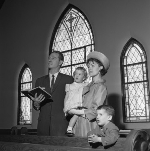 Family with daughter and son singing in church Poster Print - Item # VARSAL255420759