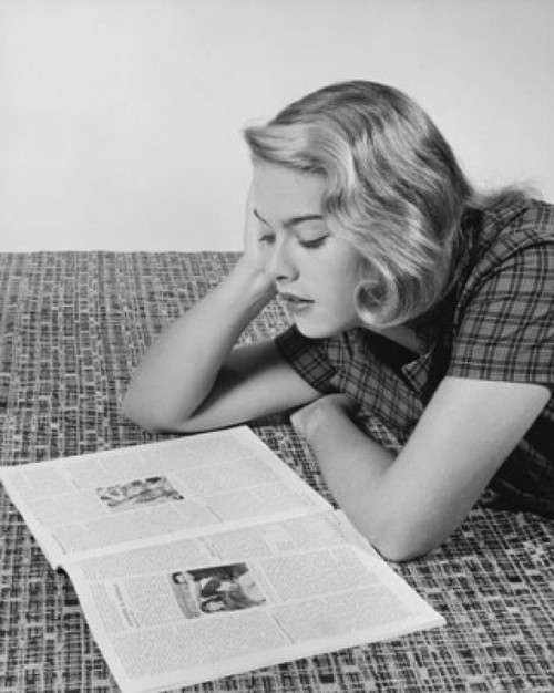 Young woman lying on the floor and reading a magazine Poster Print - Item # VARSAL2553891