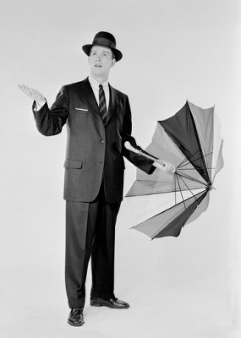 Man in suit holding umbrella and checking for rain Poster Print - Item # VARSAL255419053