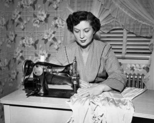 Mid adult woman sewing clothes with a sewing machine Poster Print - Item # VARSAL2551677