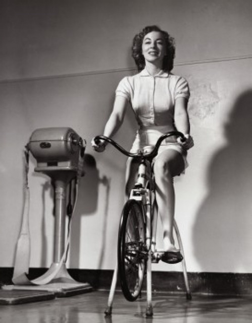 Young woman exercising on an exercise bike Poster Print - Item # VARSAL2553675